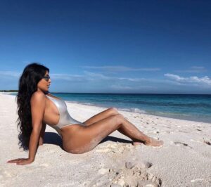 Curvaceous Kim Kardashian Posing in a Revealing One-Piece Swimsuit